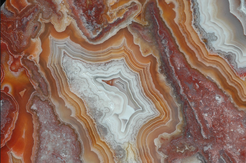 A close-up of a small polished slab of Red Agate