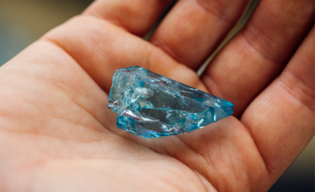 Aquamarine stone on a hand in display